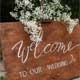 Wooden wedding sign greeting the guests. 